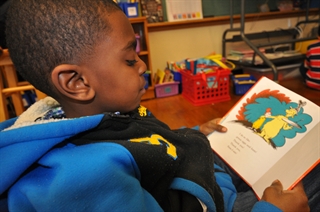 A student at MPS' 81st Street School reading a Dr. Seuss book