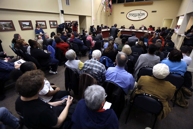 Ferguson residents pack the council chambers for a meeting of the City Council Tuesday, Feb. 2, 2016, in Ferguson, Mo. City leaders have spent months negotiating a settlement with the U.S. Department of Justice, a plan that calls for sweeping changes to police practices in the St. Louis suburb where 18-year-old Michael Brown was fatally shot. (AP Photo/Jeff Roberson)