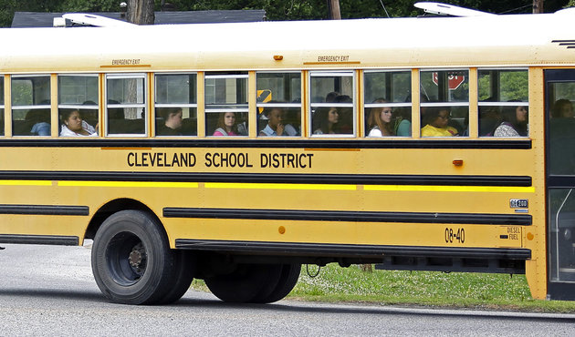 FILE- In this May 13, 2015 file photograph, an integrated group of Cleveland, Miss., public school students ride the school district bus on their way home following classes. A federal judge ruled on a desegregation case, Friday, May 13, 2016, that the Cleveland school district must merge its high schools and middle schools to achieve racial desegregation. (AP Photo/Rogelio V. Solis, File)