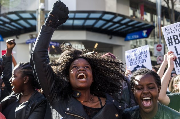 MELBOURNE, AUSTRALIA - JULY 17 : Protestors hold banners and chant slogans during a Black Lives matter rally in Melbourne, Australia on July 17, 2016. Approximately 3500 protestors rallied in Melbourne to show 'solidarity' after racial violence in US. (Photo by Asanka Brendon Ratnayake/Anadolu Agency/Getty Images)
